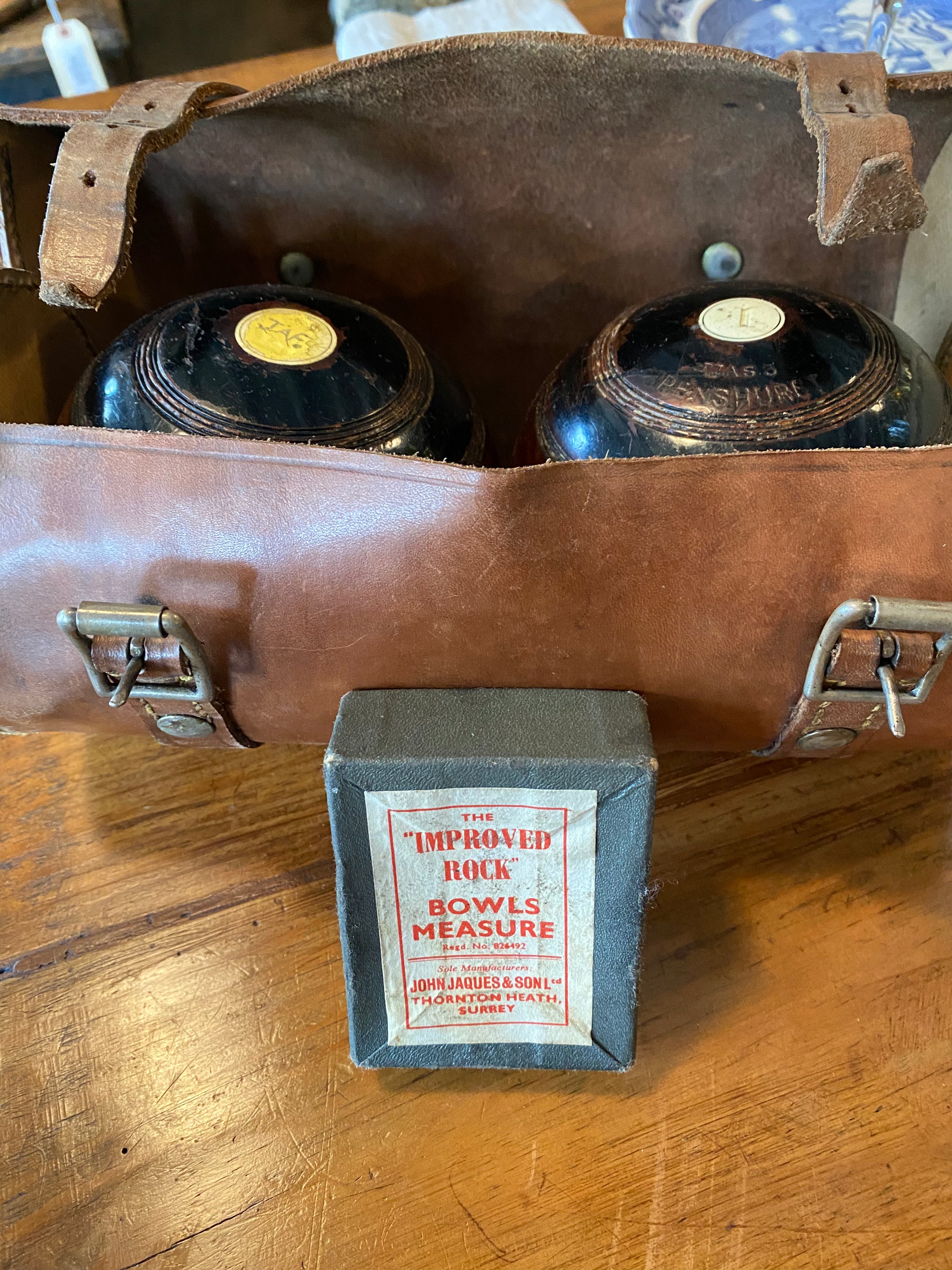 A box containing nine vintage lawn bowls. Including some very old rare A box containing nine vintage lawn bowls. Including some very old rare