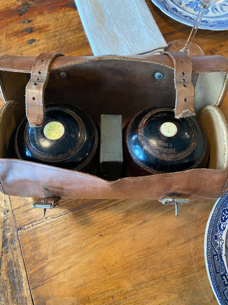 Two Lawn Bowls in a Leather Case